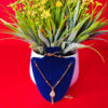 Yellow gold chain pendant with a sleek and elegant design for women.